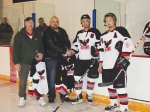 Kinsmen club members presenting the Ice Hawks with new jerseys.